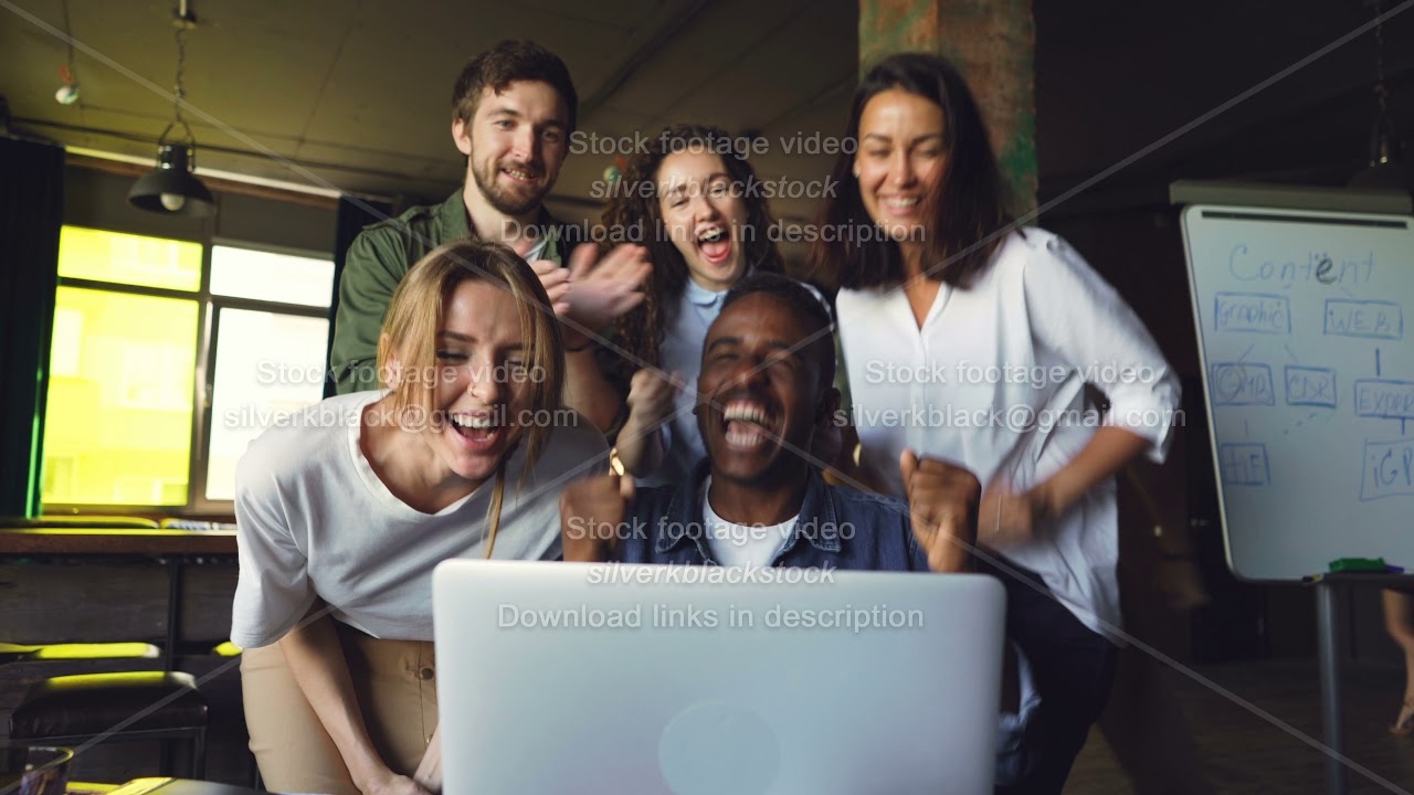 African American man office worker is excited about good news, he is looking at laptop screen and