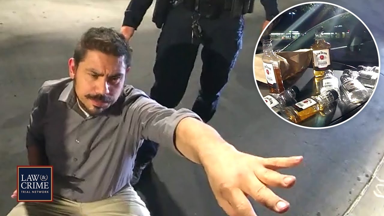 Bodycam: Drunk Man Passed Out in Fast Food Drive-Thru with Stash of Whiskey Bottles