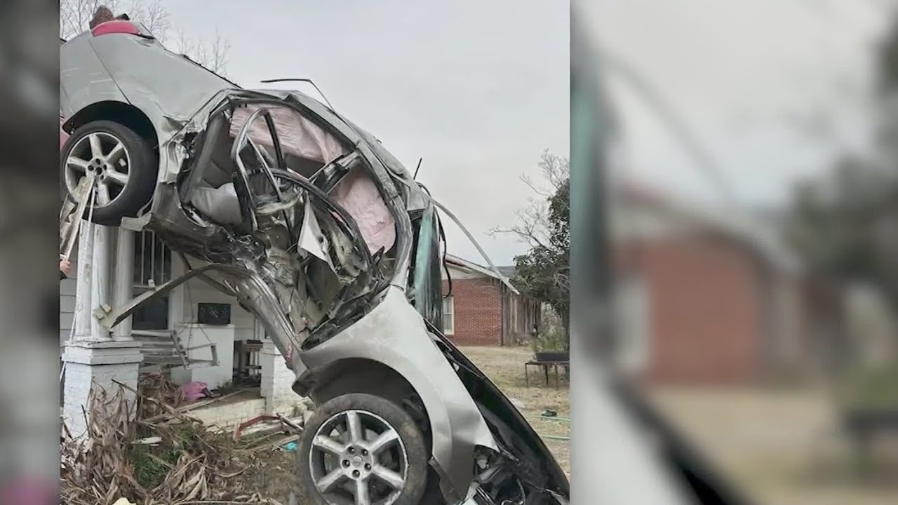 Car lands on house after hitting utility pole
