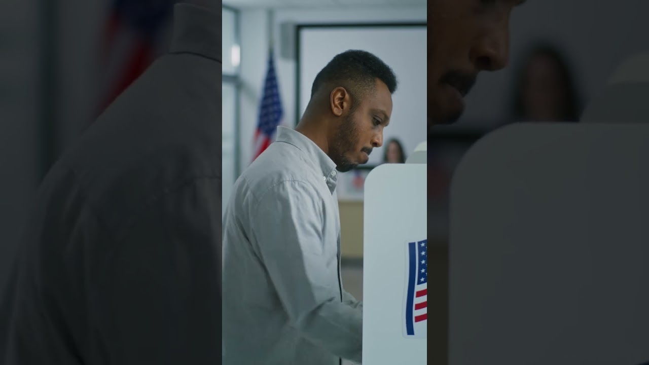 African american man takes paper ballot and walks