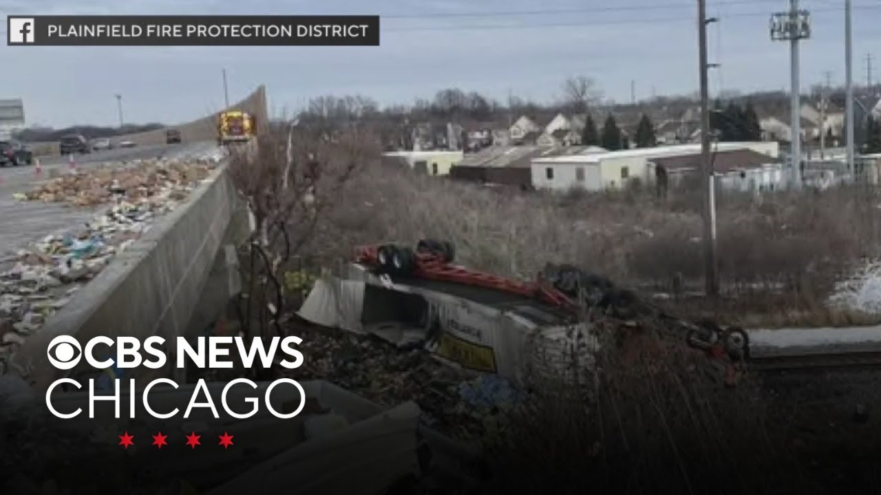 Semi-trailer truck crashes onto railroad tracks below I-55 southwest of Chicago